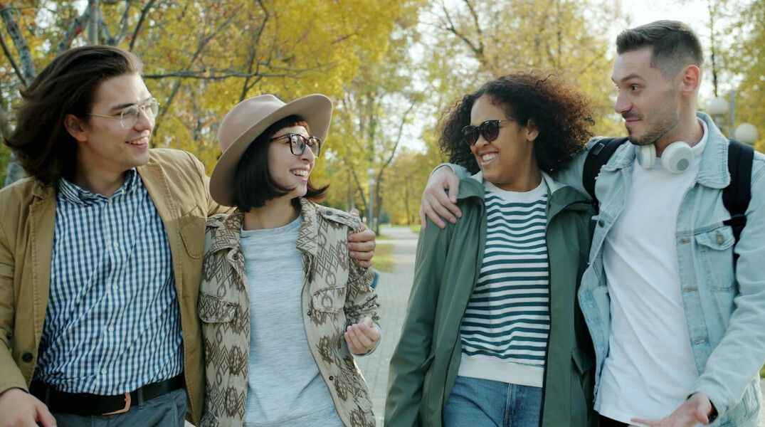 group of friends walking in park