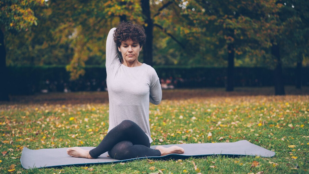 woman doing yoga in park